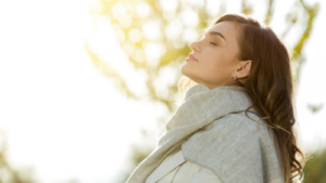 woman enjoying sun on her face.