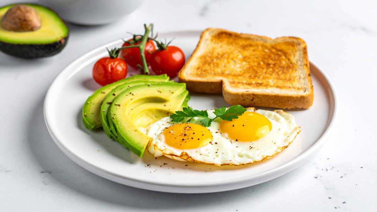 Plate with eggs, avocado, toast, and tomatoes for an easy morning breakfast