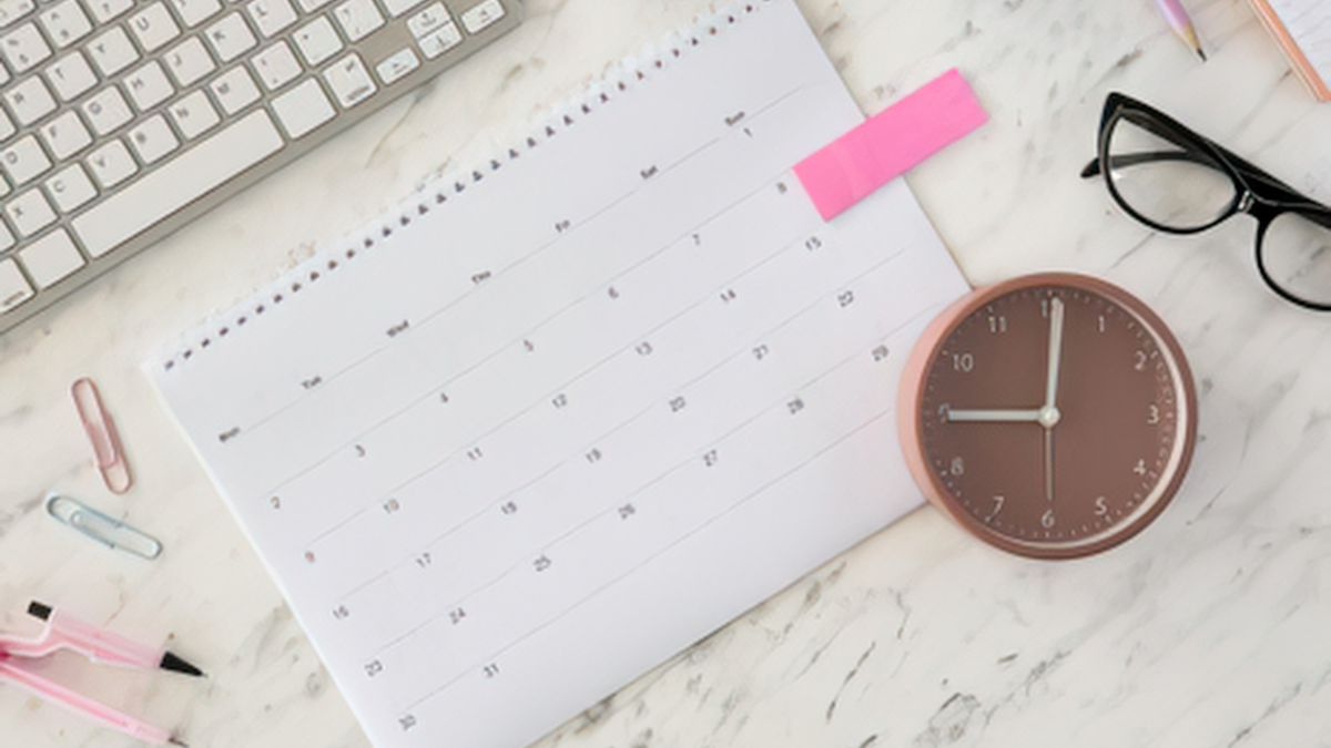 Calendar, clock, and glasses showing simple planning for slow business growth